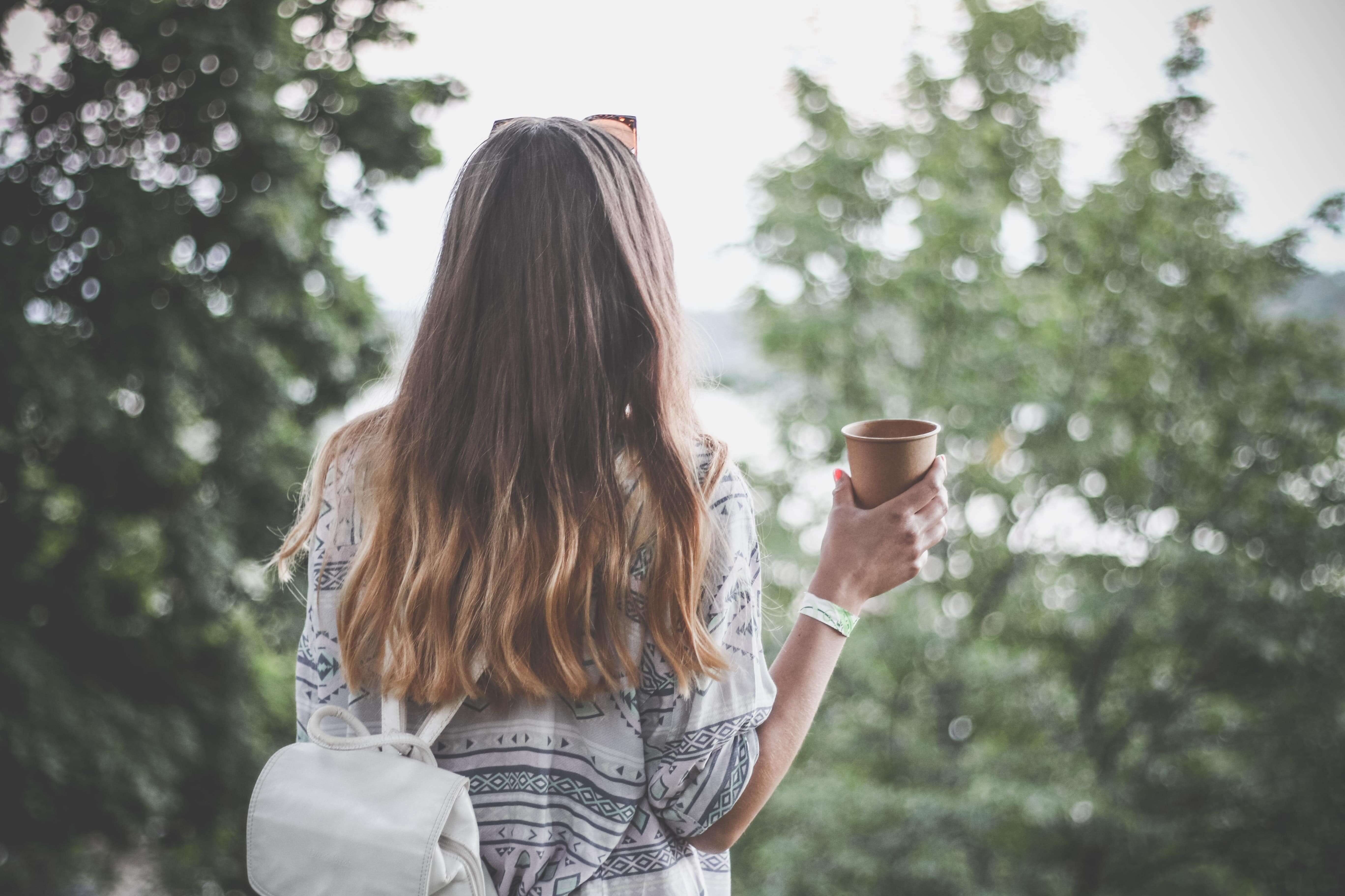 woman drinking coffee in the park